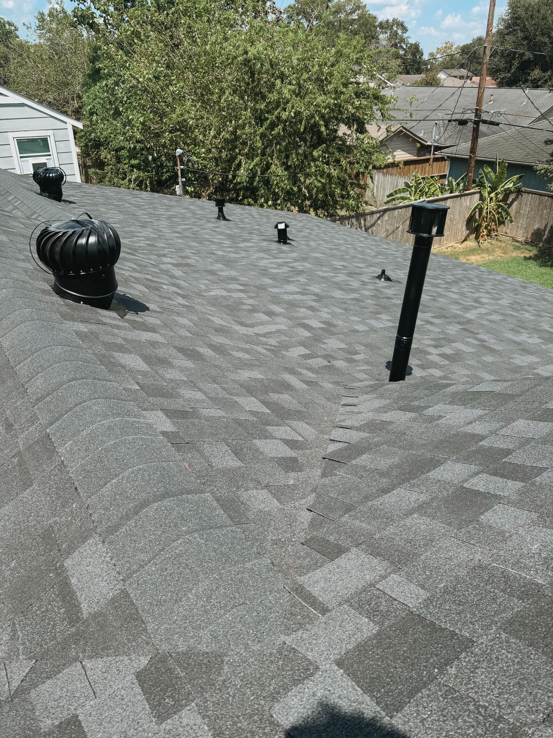 Finished Pasadena residential roof with black roof vents and pipe flashing